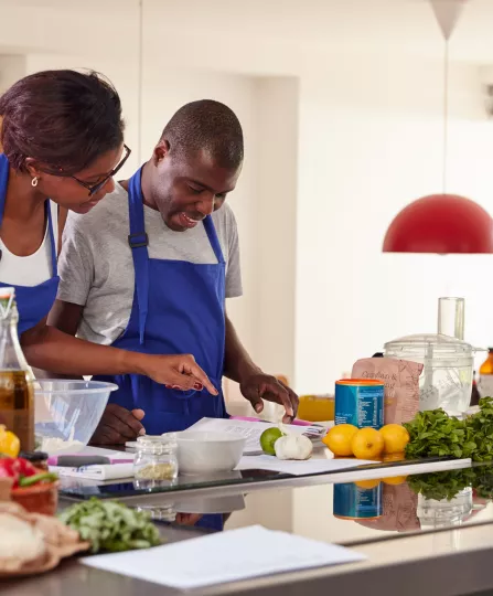 black pair at cooking class blue aprons