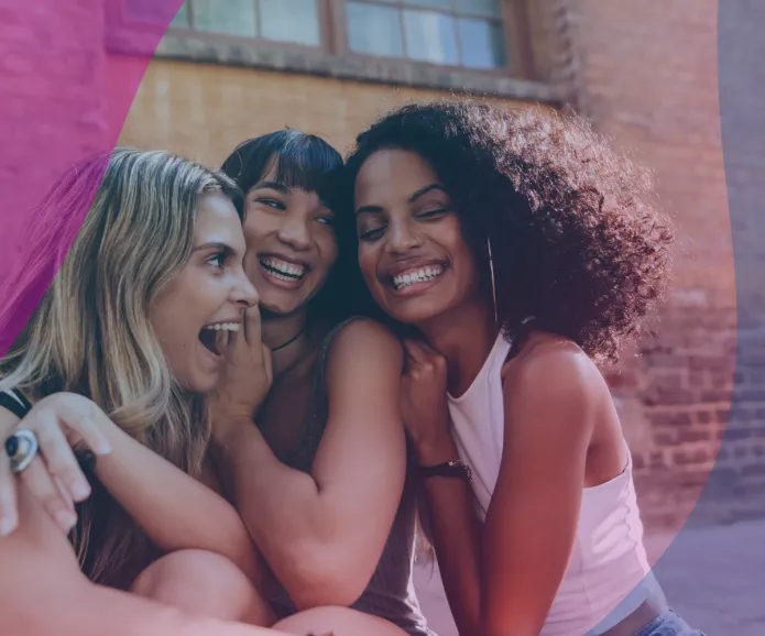 Group of young friends hugging and laughing