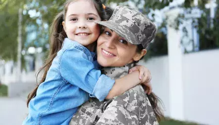 Woman in Army uniform and child