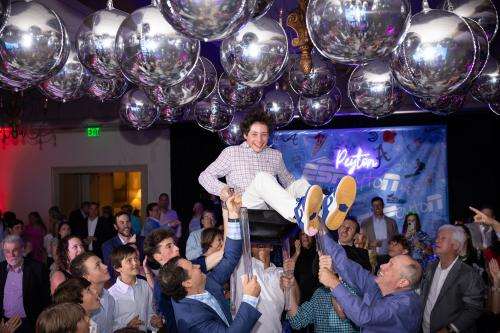 Peyton Halpern being lifted in a chair at his bar mitzvah