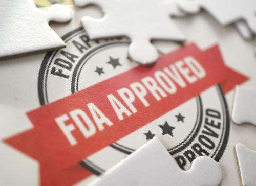 Seal with FDA Approved red ribbon and white puzzle pieces
