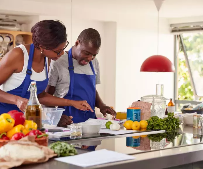 black pair at cooking class blue aprons