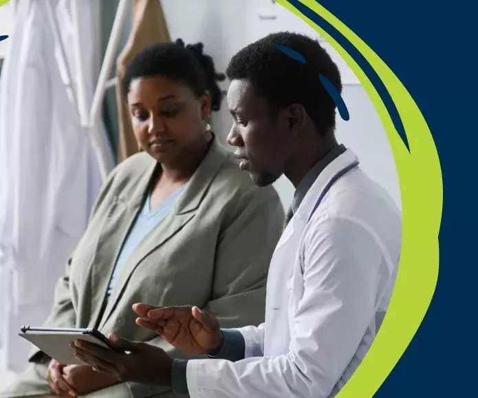 Woman reviewing tablet with doctor
