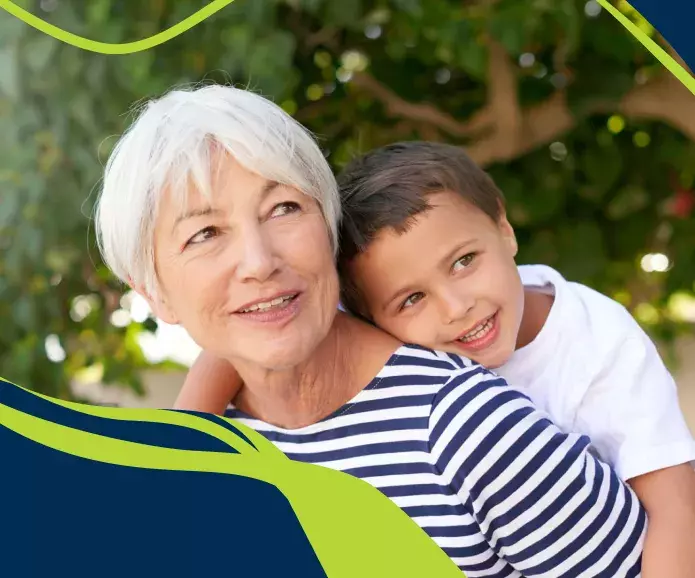 Older woman with child hugging her back