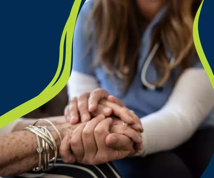 Nurse's hands holding patient's hands
