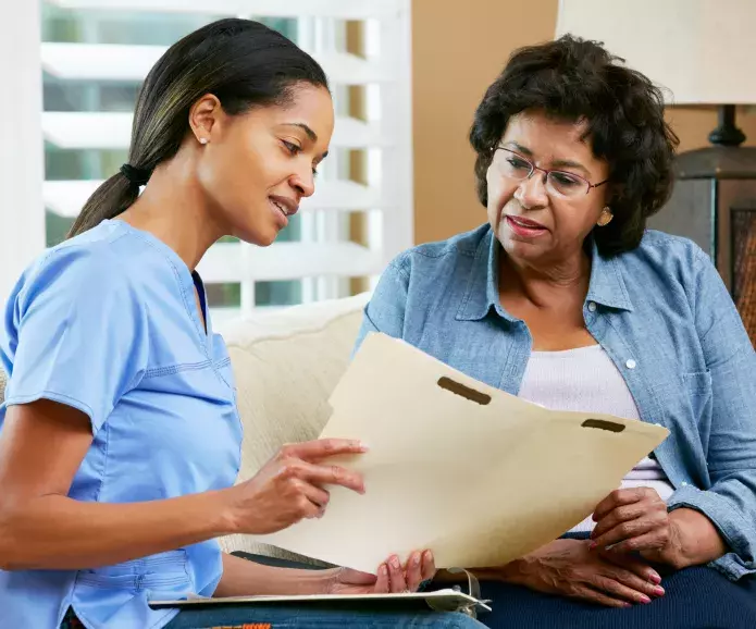 black nurse advising senior woman