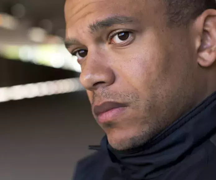 A man staring off towards the camera