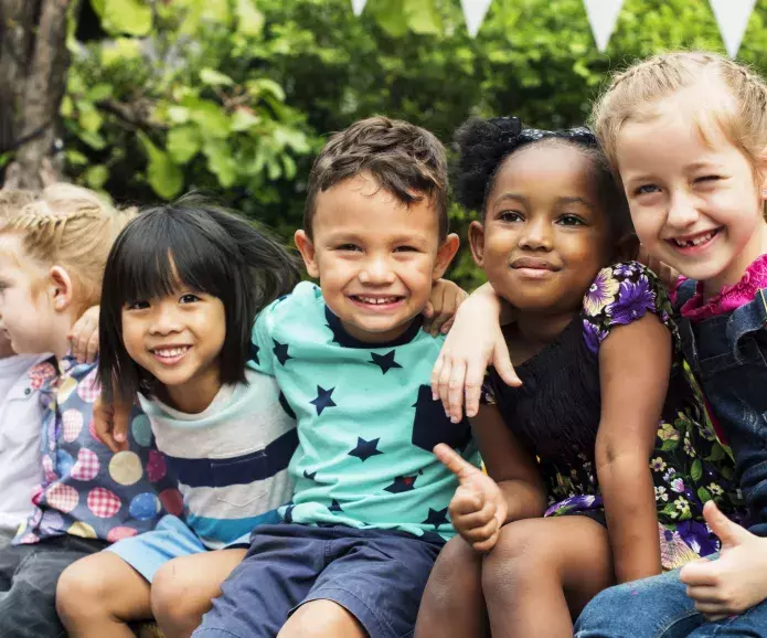 Group of young children hugging