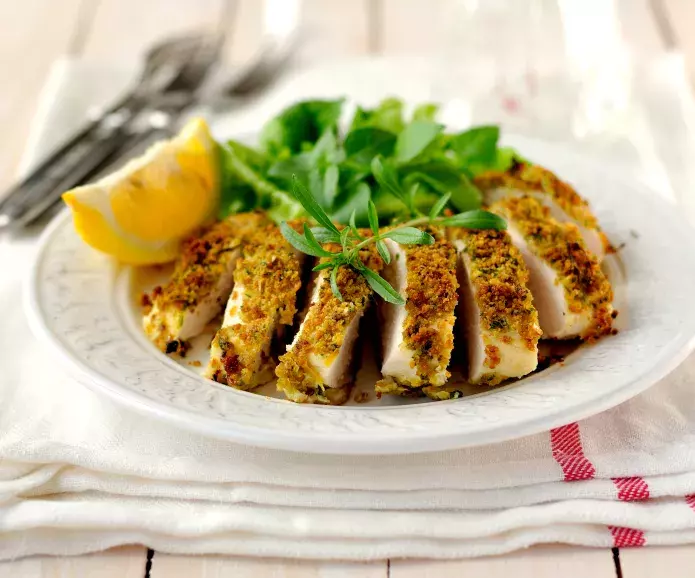 Sliced lemon herb chicken breast served on a plate
