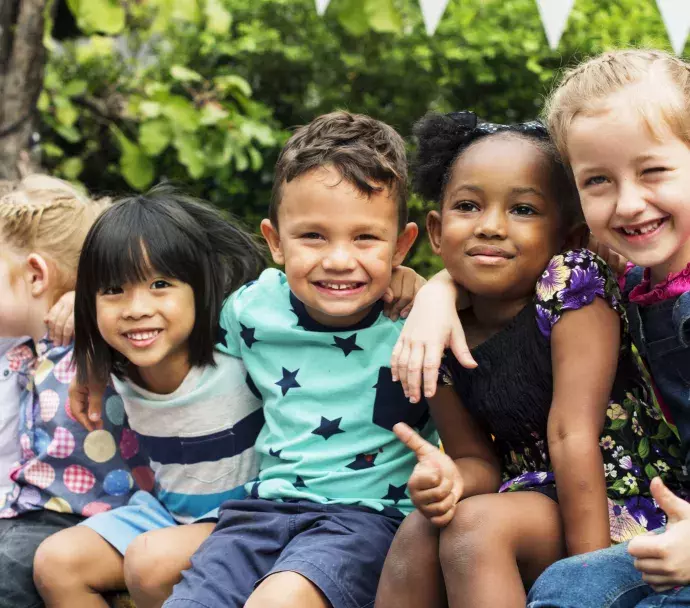 Group of young children hugging