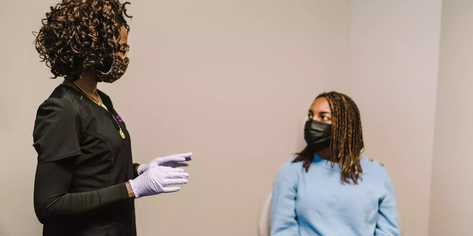 masked nurse talking with patient vaccineclinic TONL 14817