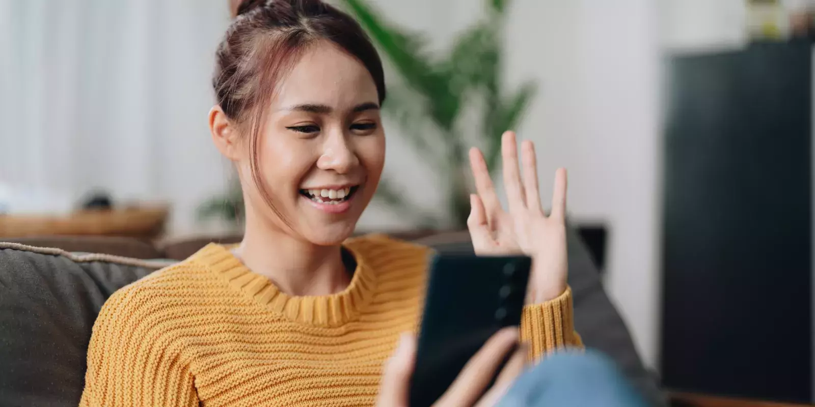 woman waving on the phone