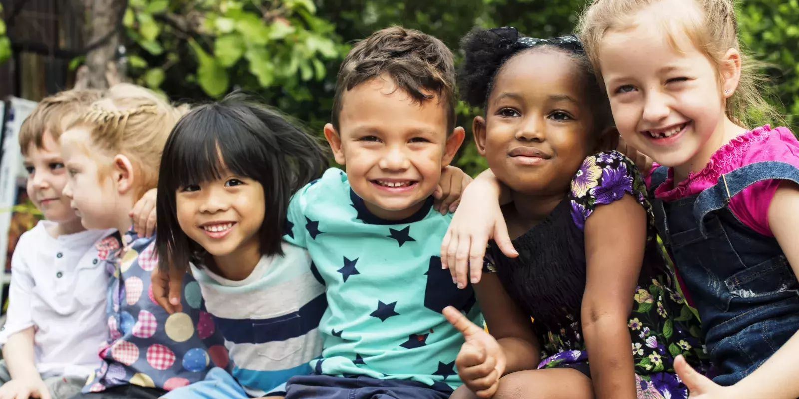 Group of young children hugging